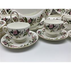 Wedgwood Hathaway Rose pattern tea and dinner wares, comprising twelve saucers, sixteen teacups, twenty tea plates, jug, sucrier, thirteen shallow bowls, sauce boat and saucer, two lidded tureens, larger jug, ten dinner plates, nine smaller plates and two large oval serving dishes