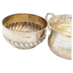 Two Victorian silver Christening sets, the first a twin handled porringer with presentation engraving to body and a matching spoon with rattail bowl, hallmarked Wakely & Wheeler, London 1898, the second example with circular part fluted bowl and matching spoon with twist handle and palmette finial, hallmarked Martin, Hall & Co, London 1884, both contained within tooled leather cases with fitted blue velvet and silk interior