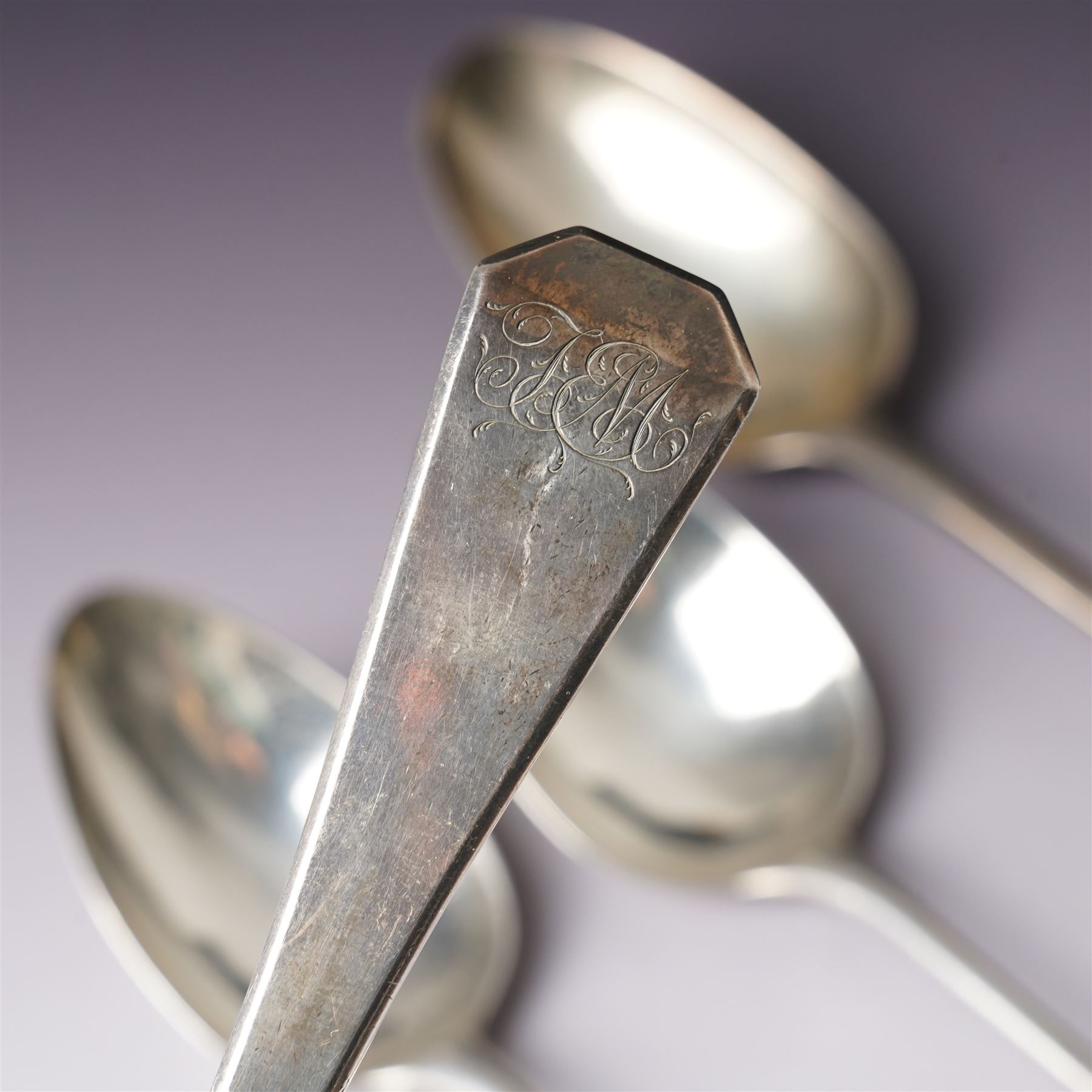 George III silver basting spoon London 1772, another engraved with initials London 1802 Thomas Wallis II, pair of table spoons London 1791 Maker Peter and Ann Bateman and two dessert spoons