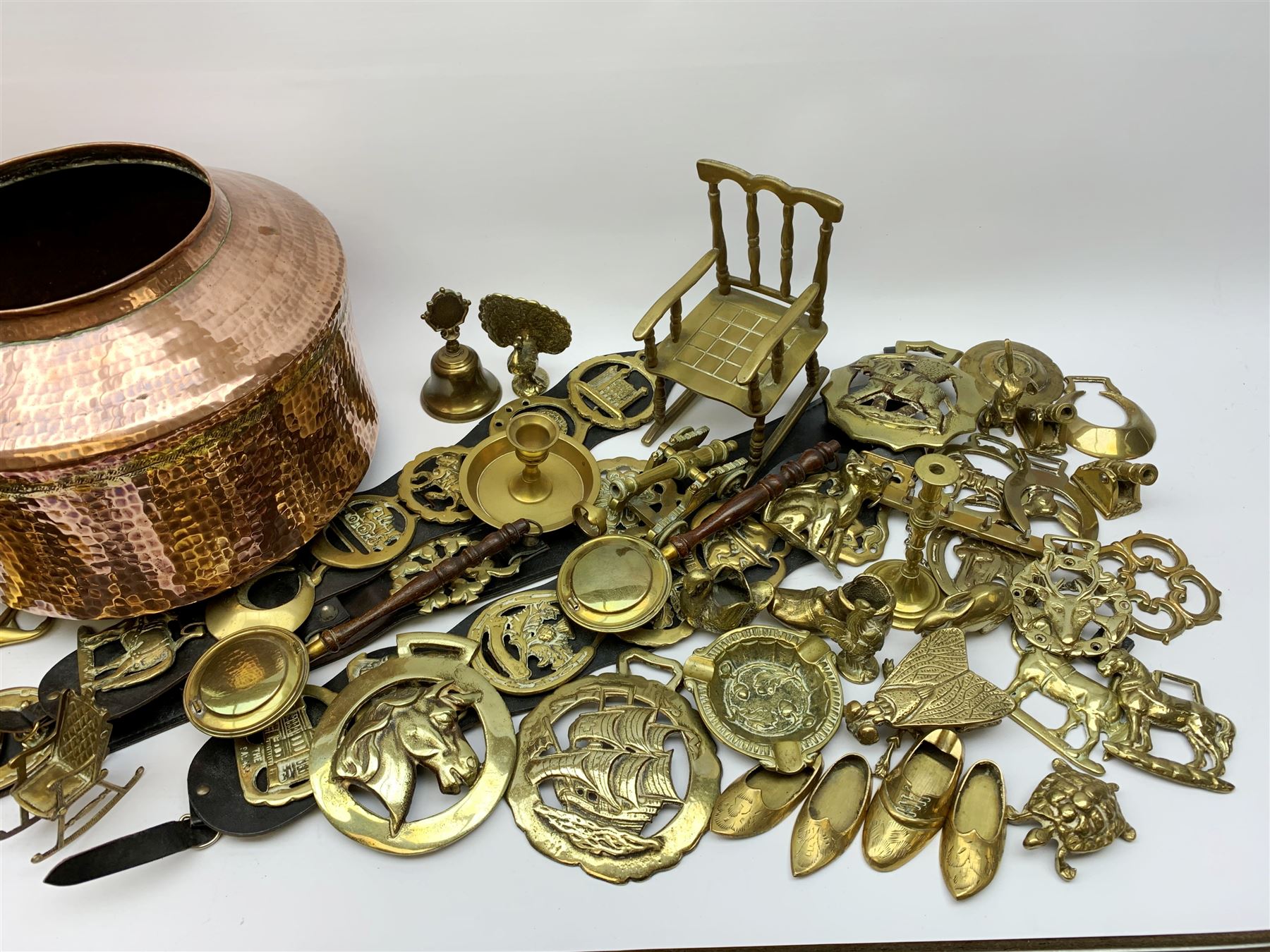 Collection of 20th century horse brasses, three on leather straps, collection of brass miniatures, copper kettle, tapered copper jug with brass handle, dolls part tea set, hand beaten copper and brass jug of Islamic/Middle Eastern origin and other metal wares 