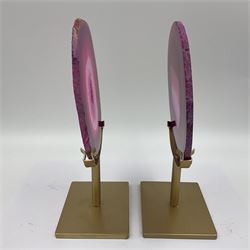Pair of pink agate slices, polished with rough edges raised upon gilt metal stands, H20cm
