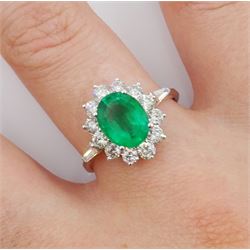 18ct white gold oval emerald and round brilliant cut diamond cluster ring, with tapering baguette cut diamond shoulders, stamped 750, emerald approx 1.50 carat, total diamond weight approx 0.90 carat