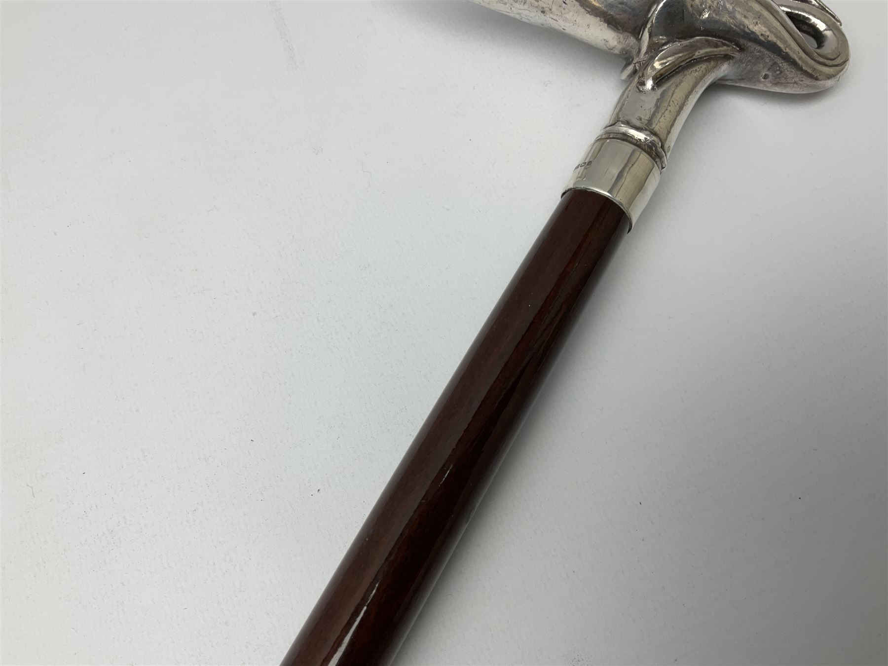 Art Deco style Italian 'Rivestito' covered silver walking stick handle, modelled in the form of a swan, stamped 'R', upon a silver collar hallmarked Birmingham 1986, makers mark DH-L, and hardwood shaft, L96cm

Provenance by vendor repute: 
This walking cane comes from a private collection amassed by the current vendors mother who was an Antique dealer specialising in walking sticks, working at the Portobello Road Antique Market in London for over forty years. 
In 1988 the prop crew from LWT (now ITV) visited Portobello Road looking for, amongst other items, a signature stick for David Suchet to use in his portrayal of Agatha Christie's Poirot. 
At the time this particular walking stick was one of five in possession. The prop crew chose and purchased another of the five which was then used by Suchet throughout all seventy episodes of the much loved series. 
Following the conclusion of the series Suchet was gifted his particular cane, which has been loaned to and can now be seen at the Agatha Christie Gallery at the Torquay Museum. 
