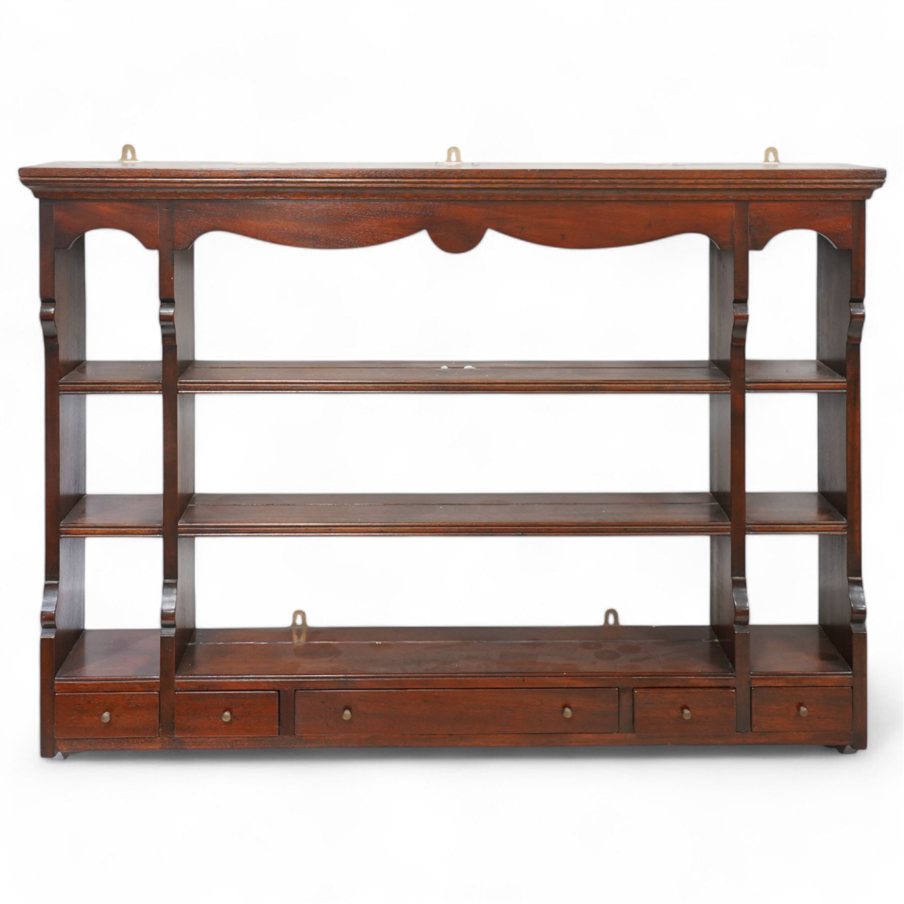 Georgian design mahogany wall rack, moulded cornice over shaped frieze and thee shelves, fitted with five drawers