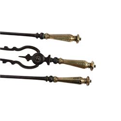 Set of three 19th century brass and steel fire irons, each with tapering and hexagonal capped handles, comprising poker, tongs and shovel with pierced detail, poker L84cm