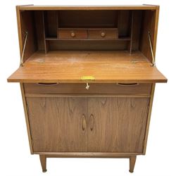 Mid-20th century teak bureau, fall front enclosing fitted interior, single drawer over double cupboard 