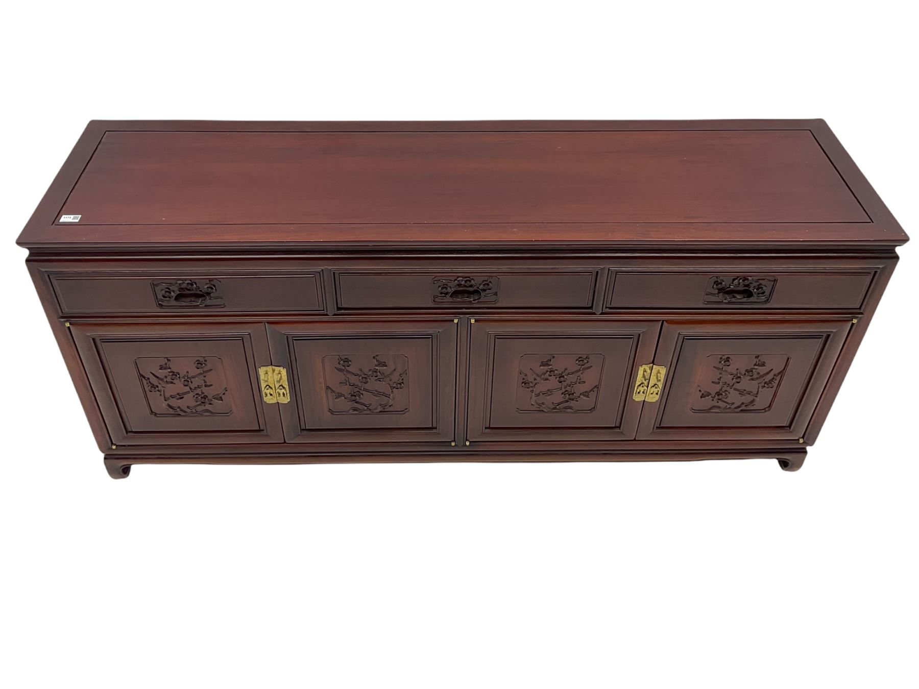Chinese hardwood sideboard, three drawers above four cupboards, the doors relief carved with flowers and birds 