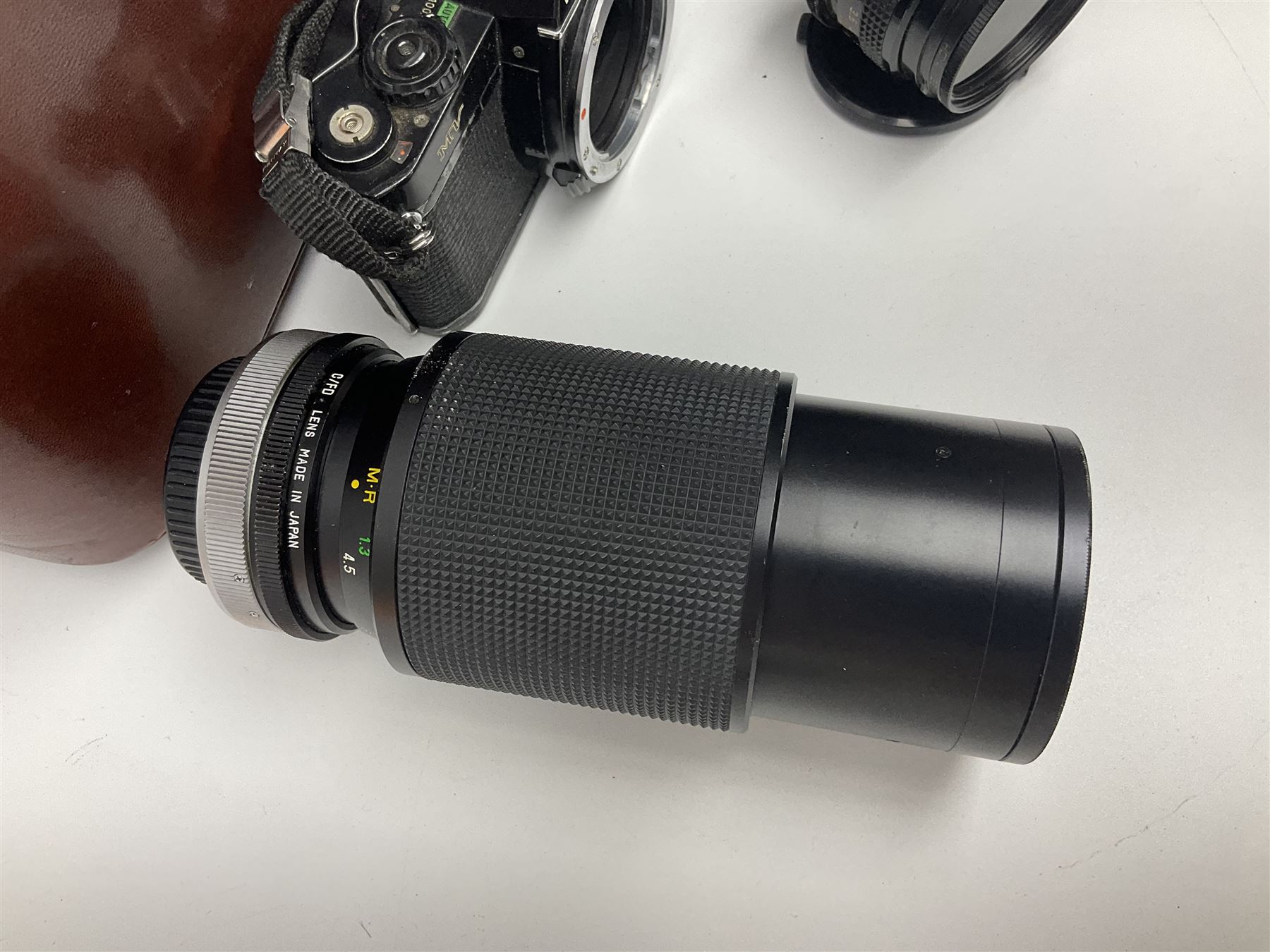 Four Minolta camera bodies, to include Dynax 500si, serial no. 94812651 with 'Signa Zoom 1;3.5-4.5 f=28-70mm' lens, Maxxum 300si, serial no. 97821665, with 'Tamron AF 80-210mm' lens and Dynax 300si, serial no 01603265'  with Minolta AF Power Zoom 35-80mm 1;4' lens, etc, together with Pantax MV1 camera bodies and other camera equipment 