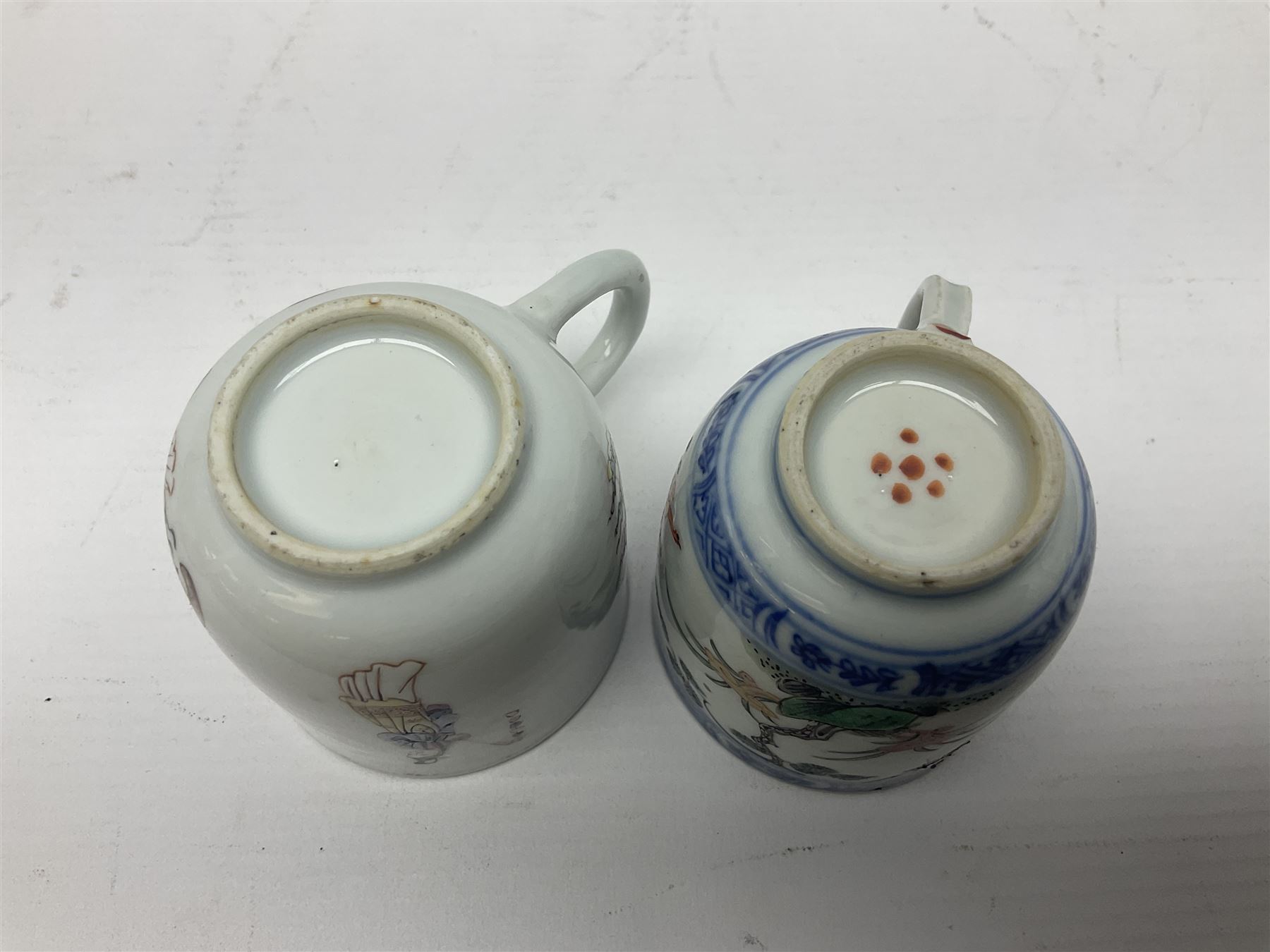Two 18th century Chinese Yongzheng coffee cups, the first example decorated in polychrome enamel with rooster amidst blossoming peonies, the second decorated with deer and crane among rockwork and pine tree, together with two further 18th century Chinese coffee cups, an 18th century Chinese tea bowl, and a further tea bowl