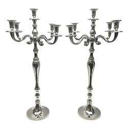Pair of four branch candelabras, urn-shaped nozzles raised upon scroll branches supported from tapering central stem, with circular base, H70cm