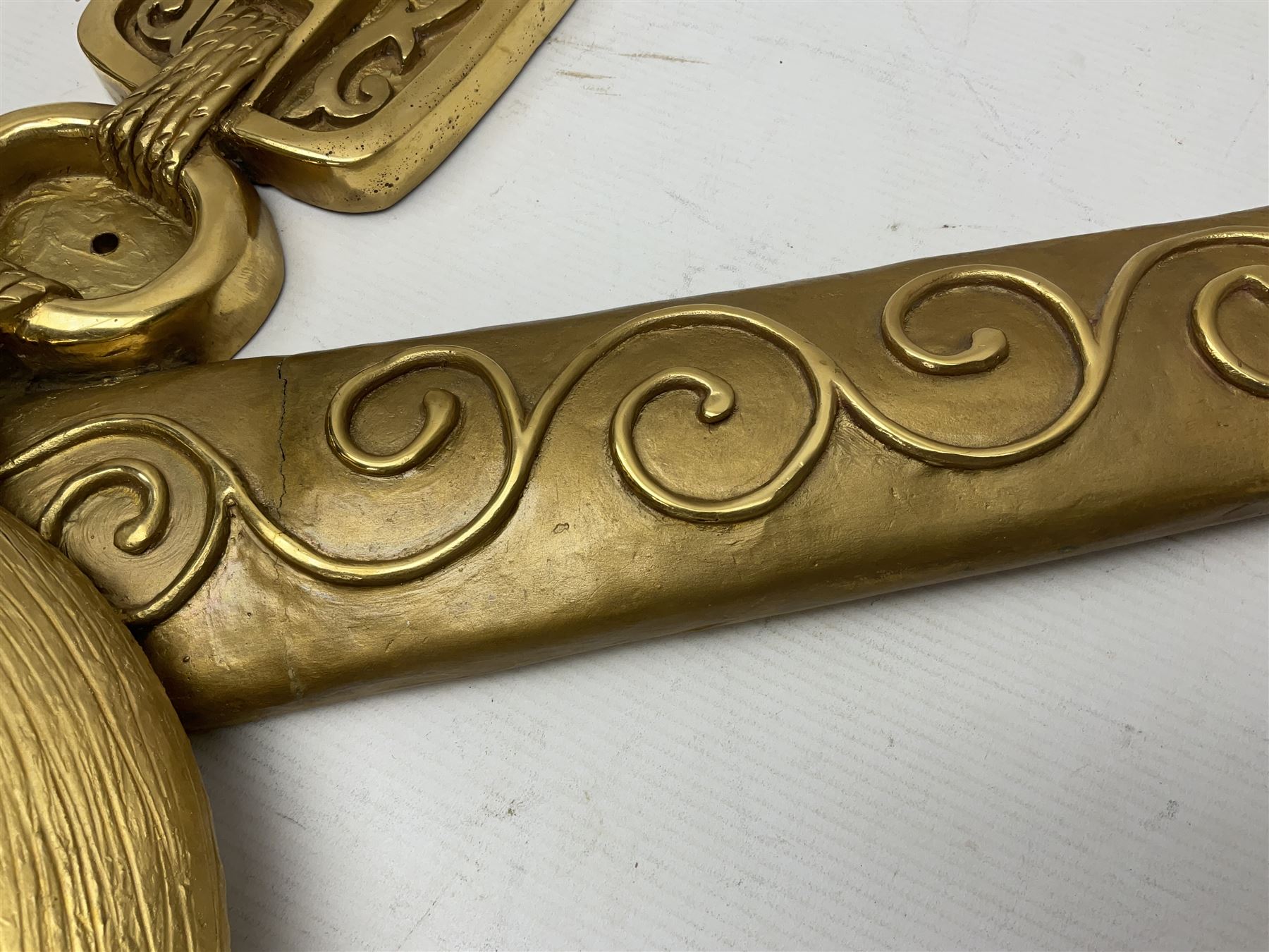 Gilt state emblem for Oman, a sheathed khanjar dagger superimposed above pair of crossed swords and belt and a seperate crown, main emblem H84cm, W83cm, crown H35cm, W33cm
Provenance by vendor repute: The emblem was previous mounted above HM's throne, in the main majalis, of the HM Royal Yacht AL Said, until 1985 when HM Sultan Qaboos ordered the upgrading of all state emblems, The emblem was gifted to the vendor who worked for the Sultans Royal Yacht Squadron