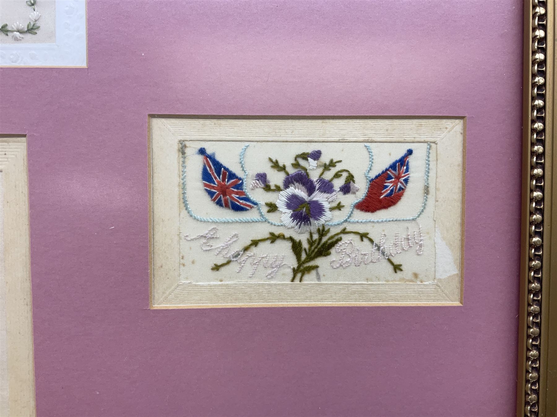 Thirty-five WW1 embroidered silk postcards including regimental crests, flags of the Allies, envelope type with greeting card inserts, Christmas and birthday cards etc; mounted and glazed in three graduated modern matching gilt frames (3)