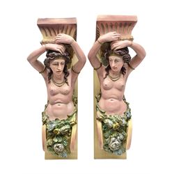 Pair of fairground moulded supports from a roundabout, modelled as semi nude female figures, surrounded by gilt floral sprigs, H71cm, D36cm  