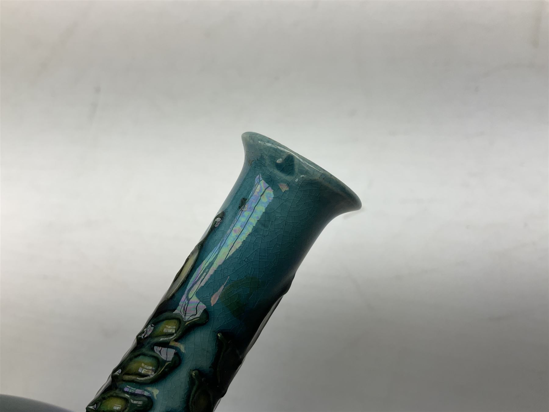 Minton Secessionist vase, with tube-lined stylised flower decoration, upon a blue ground, with printed mark to base 'Minton Ltd, No. 32', H13cm