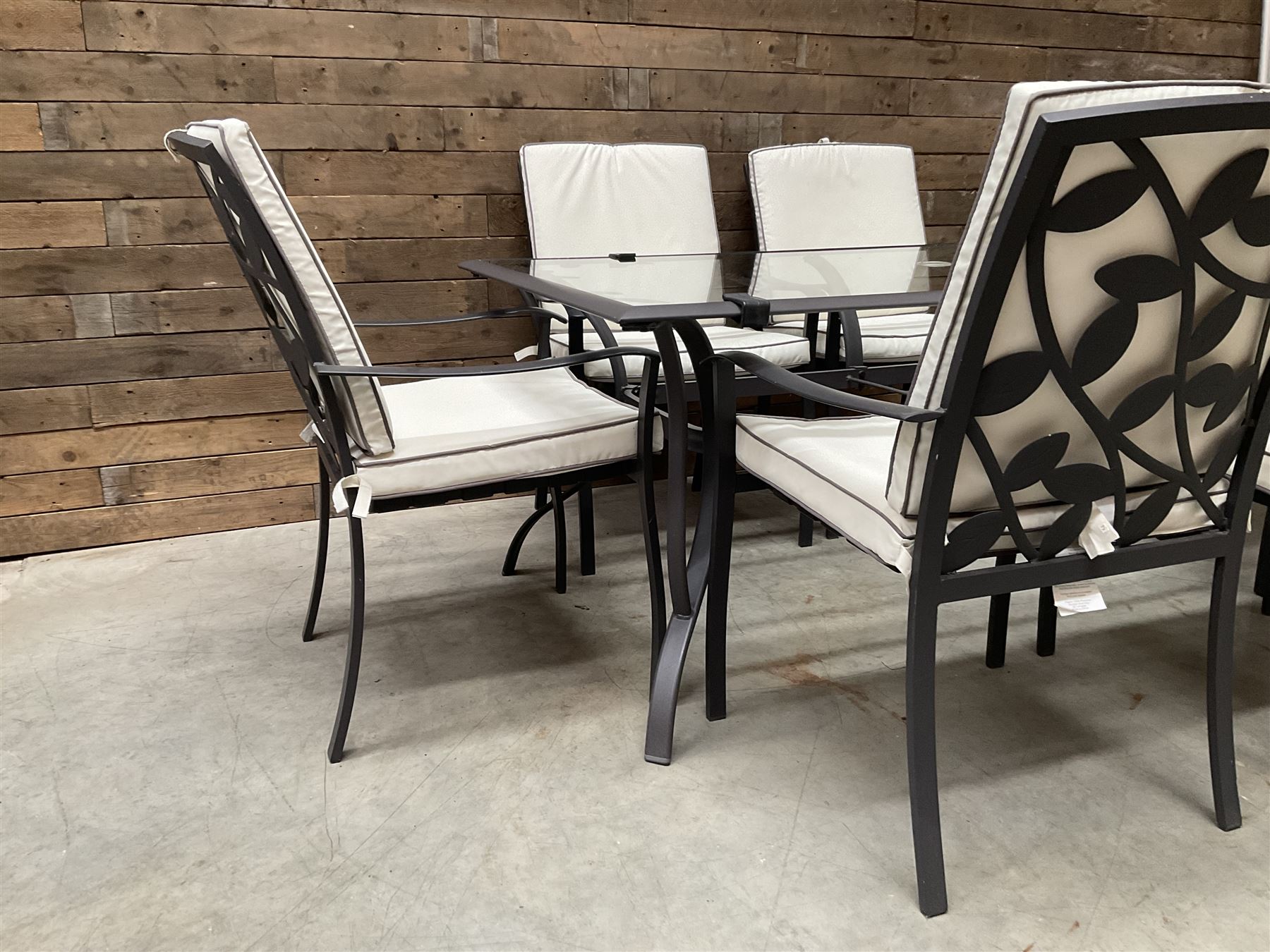 Metal framed garden table with glazed top (W170cm, D102cm, H71cm) and six armchairs with cushions 