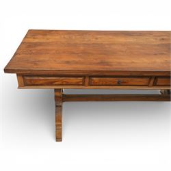 20th century Spanish design oak dining table, large rectangular top above a run of three drawers to the frieze, standing on shaped trestle supports with scroll cut details and stretcher base