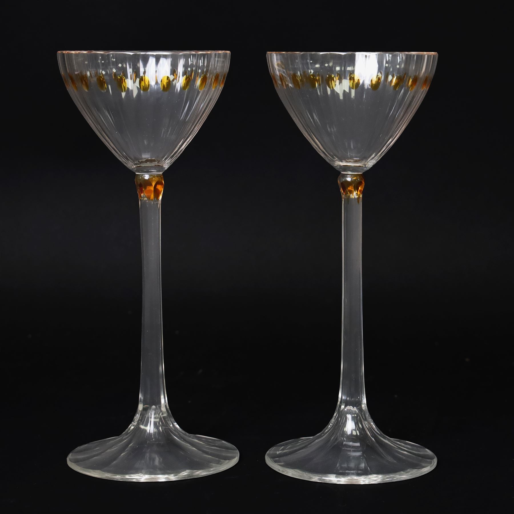 Otto Prutscher (1880-1949) - pair of early 20th century crystal wine glasses with citrine coloured ovals to the bowl and yellow stained at the top of the stem on a trumpet shape foot H21cm
Notes: The glasses were probably made at the Meyr's Neffe glassworks, Adolf, Bohemia for the retailer E Bakalowits & Sohne, Vienna circa 1909 