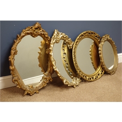  Four ornate moulded gilt framed mirrors  