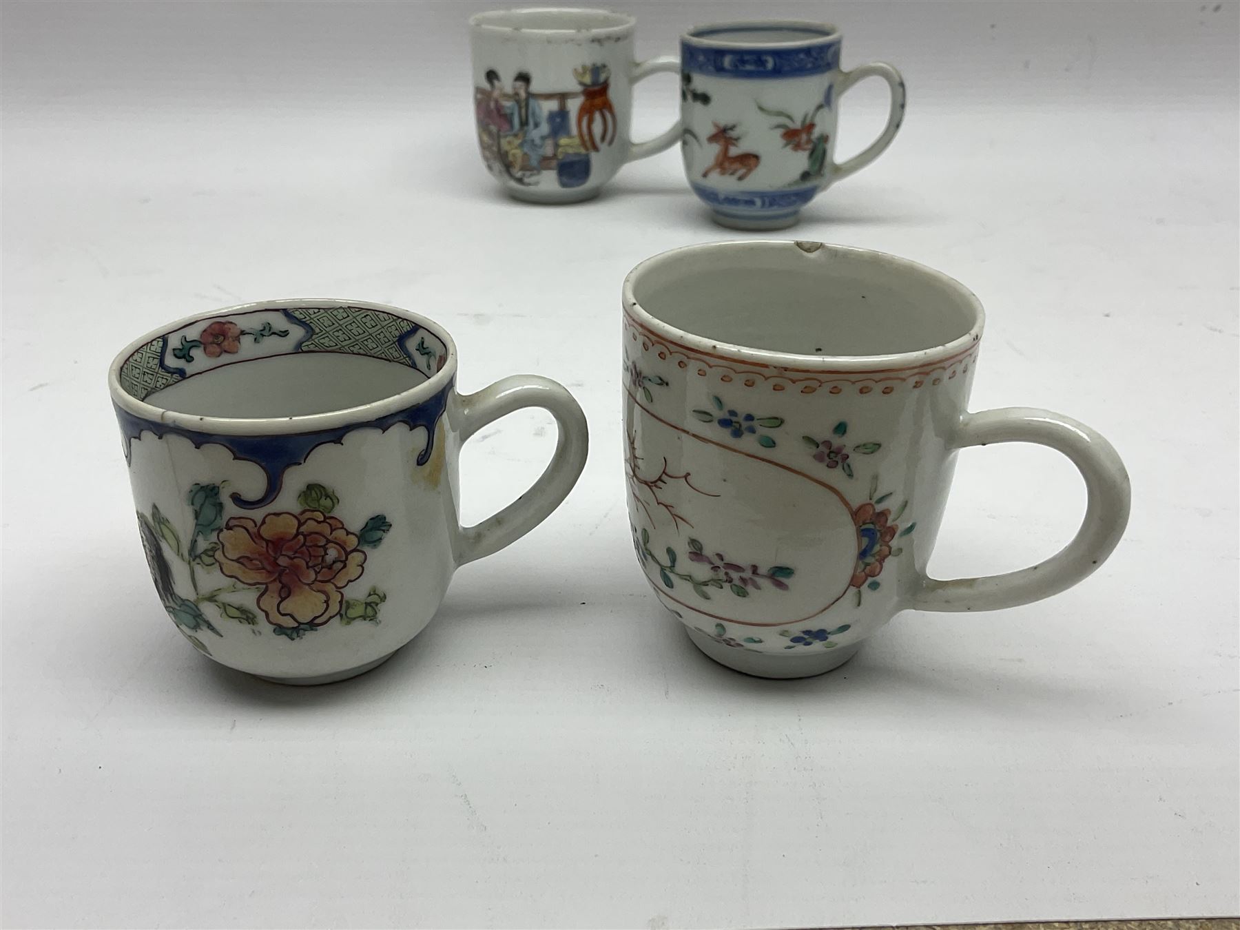 Two 18th century Chinese Yongzheng coffee cups, the first example decorated in polychrome enamel with rooster amidst blossoming peonies, the second decorated with deer and crane among rockwork and pine tree, together with two further 18th century Chinese coffee cups, an 18th century Chinese tea bowl, and a further tea bowl
