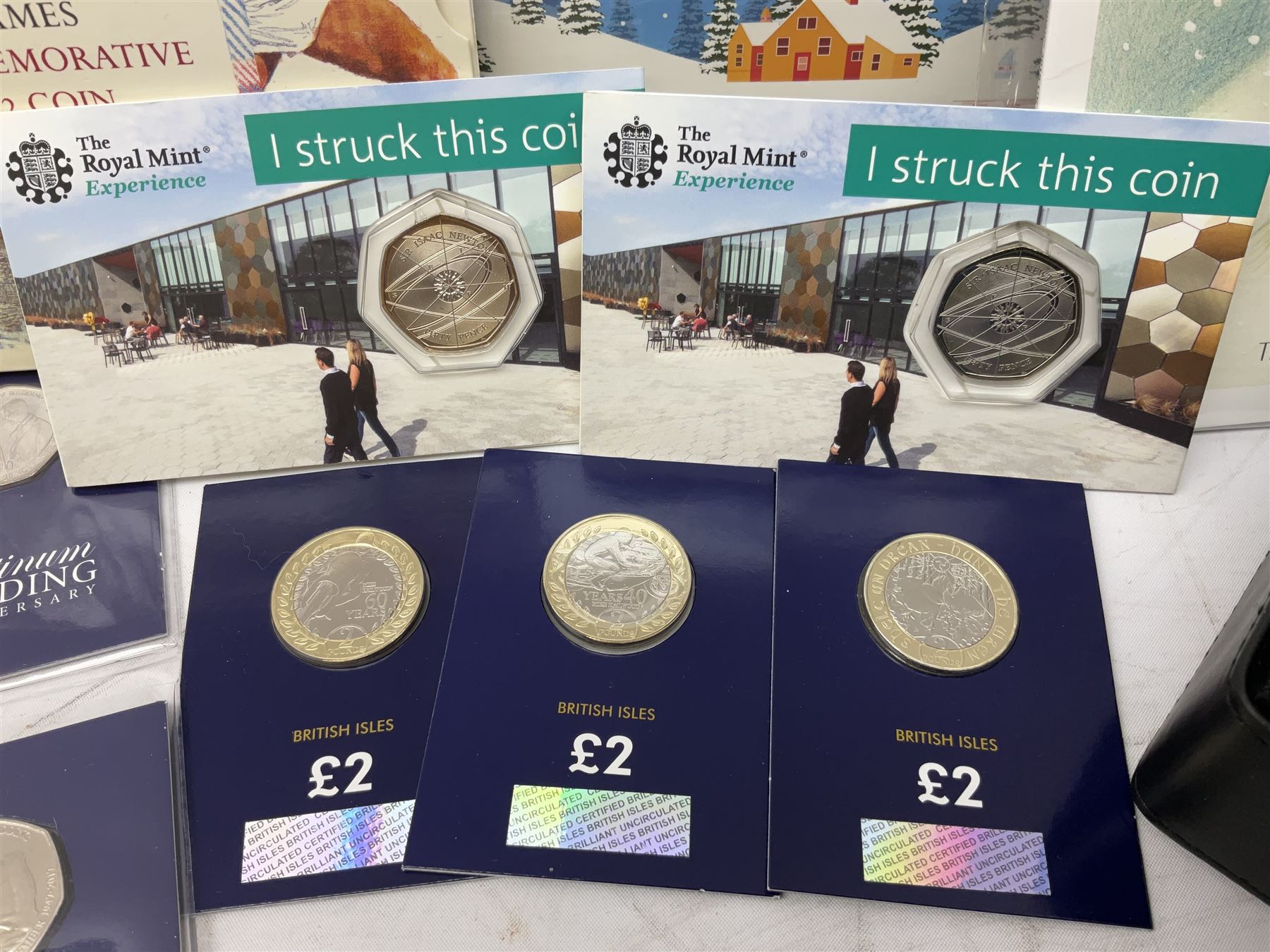 Great British and World coins, including two The Royal Mint Experience 2018 Sir Isaac Newton fifty pence coins on cards, commemorative crowns, Queen Elizabeth II 1999 five pounds, pre-decimal coinage, various Isle of Man fifty pence pieces etc