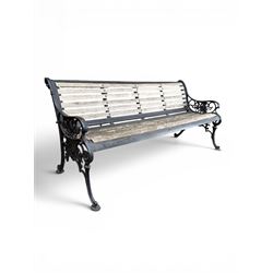 Victorian Andrew McLaren pattern cast iron bench, the ornate ends with detailed scrollwork, joined together with a cast iron seat and backrest frame supporting gently weathered oak slats, Victorian diamond stamp mark