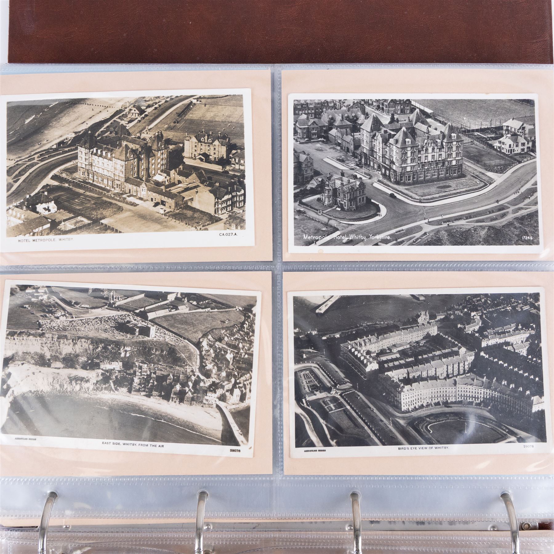 Two-hundred and thirty eight early 19th century to 20th century Whitby view postcards, including twenty-four early 19th century court cards, seventeen views of Whitby Abbey, forty depicting the fishing fleet and harbour, with a selection of cards providing a detailed study of the early 'Yards' the fisherman's dwellings around the harbour, all housed within a Stanley Gibbons Picture Postcard Album