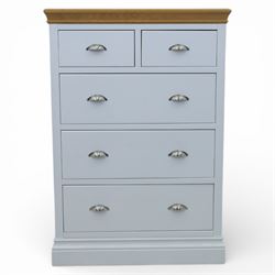 Modern chest of two short and three long drawers in white finish with oak moulded top, with metal cup handles, raised on a moulded plinth base