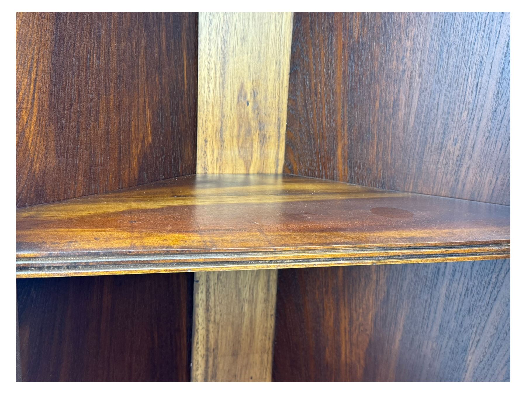 Late 20th century mahogany corner cabinet, dentil moulded cornice above a glazed door with astragal glazing enclosing two shelves, lower cupboard with fielded panel door and turned shell motif, on plinth base