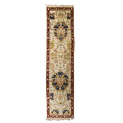 Agra wool runner, cream field decorated with large stylised palmettes, scrolling vines and...