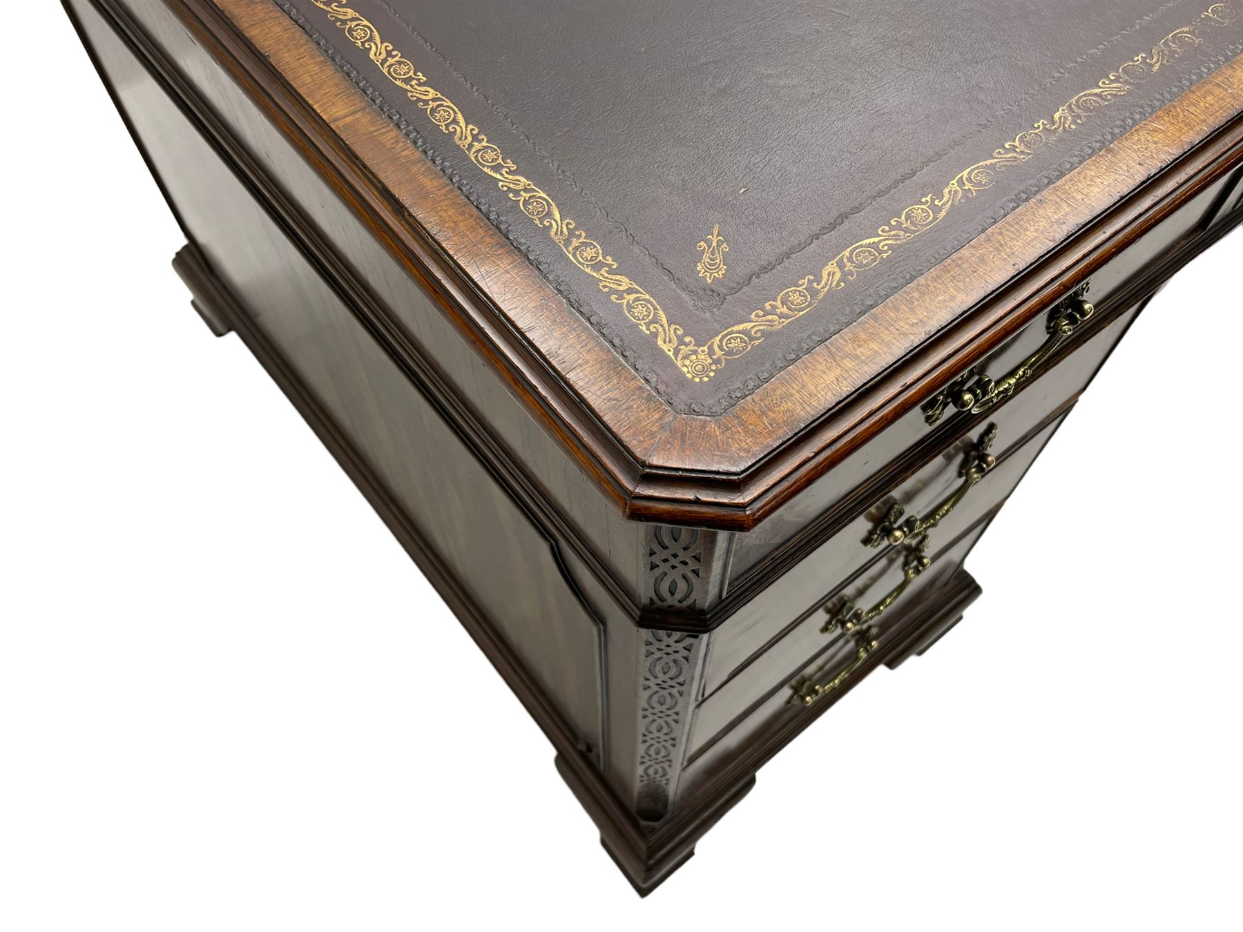 Large Georgian design mahogany twin pedestal partner's desk, moulded rectangular top with canted corners and inset leather writing surface, fitted with nine drawers and two cupboards, the pedestals with canted uprights decorated with blind fretwork, on ogee bracket feet