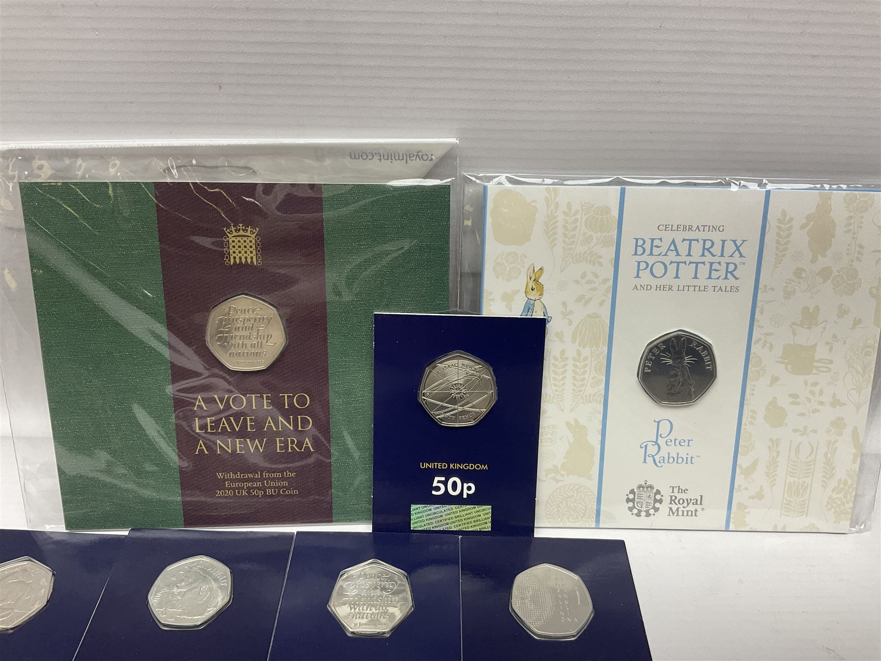 Mostly United Kingdom Queen Elizabeth II commemorative fifty pence coins, including 2019 'Gruffalo', 2020 'Iguanodon', 2022 'The Queen's Jubilee' etc, housed on cards, face value of UK coins approximately 20 GBP