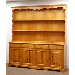  Pine farmhouse dresser, two tier plate rack above four drawers and cupboards, shaped plinth base, W193cm, H203cm, D43cm  