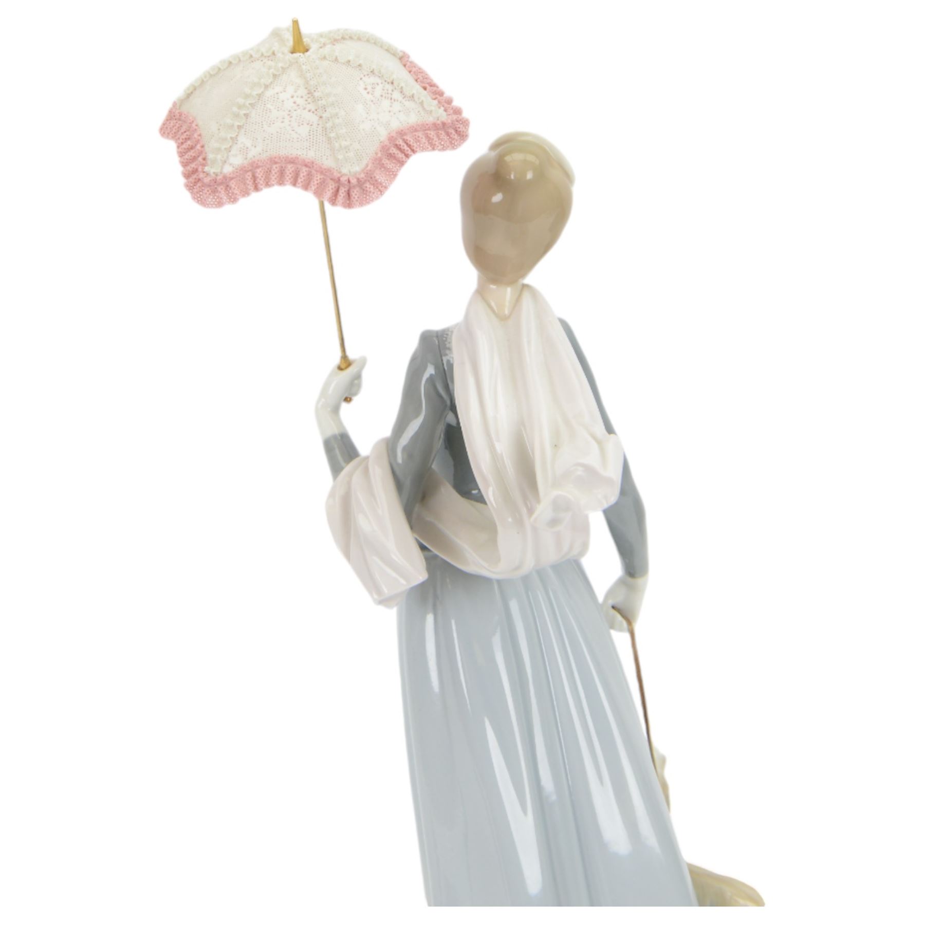 Lladro figure, Lady with Shawl, modeled as a woman holding a parasol with an afghan hound, model no 4914, H46cm 
