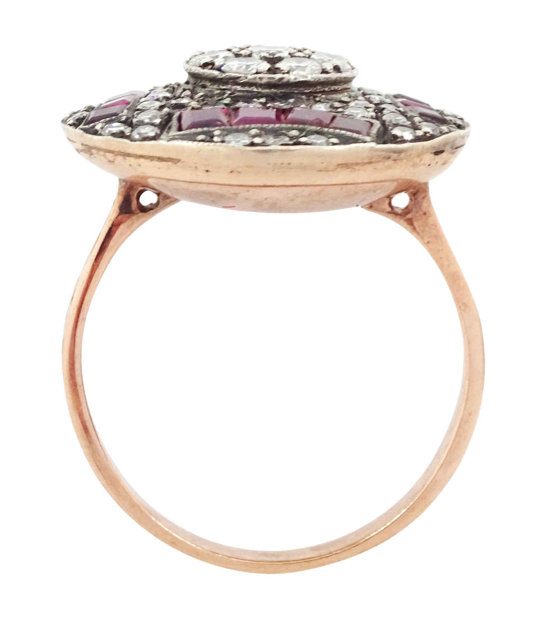 Rose gold and silver ruby and diamond circular ring, the central cluster set with eight round brilliant cut diamonds, with calibre cut ruby and single cut diamond surround, total diamond weight approx 0.90 carat, total ruby weight approx 0.75 carat
