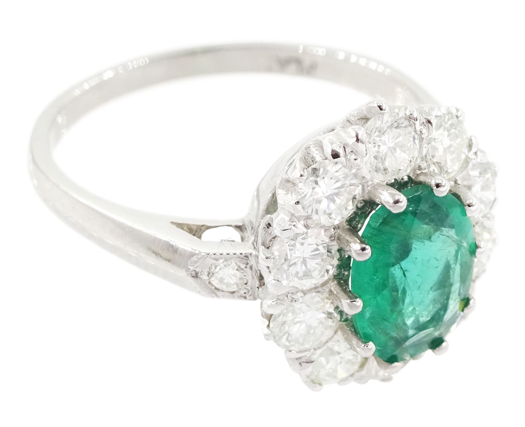 Platinum emerald and diamond cluster ring, single oval cut emerald of approx 0.90 carat, surrounded by ten round brilliant cut diamonds, and milgrain set diamond shoulders, stamped Plat, total diamond weight approx 1.00 carat