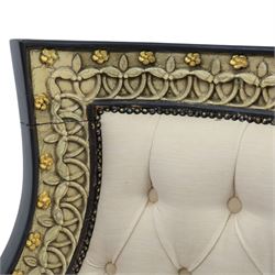 20th century Louis XVI style settee, upholstered in cream fabric with buttoned back and arms, and plain seat cushions, the shaped and black painted frame with entwined foliate detail and gilt flower heads, upon column legs with bun feet