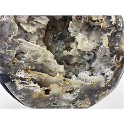 Large agate geode with quartz crystals to the centre, upon a metal stand, H35cm 