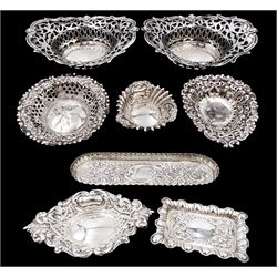 Pair of Edwardian silver bon bon dishes, of oval form, with shaped rims and pierced sides, each corner repousse decorated with dog masks, hallmarked Charles S Green & Co Ltd, Birmingham 1905, together with a Victorian silver dressing table tray, with foliate and floral decoration, hallmarked William Hutton & Sons Ltd, London 1900, and five other silver bon bon dishes etc, each hallmarked with various dates and makers 