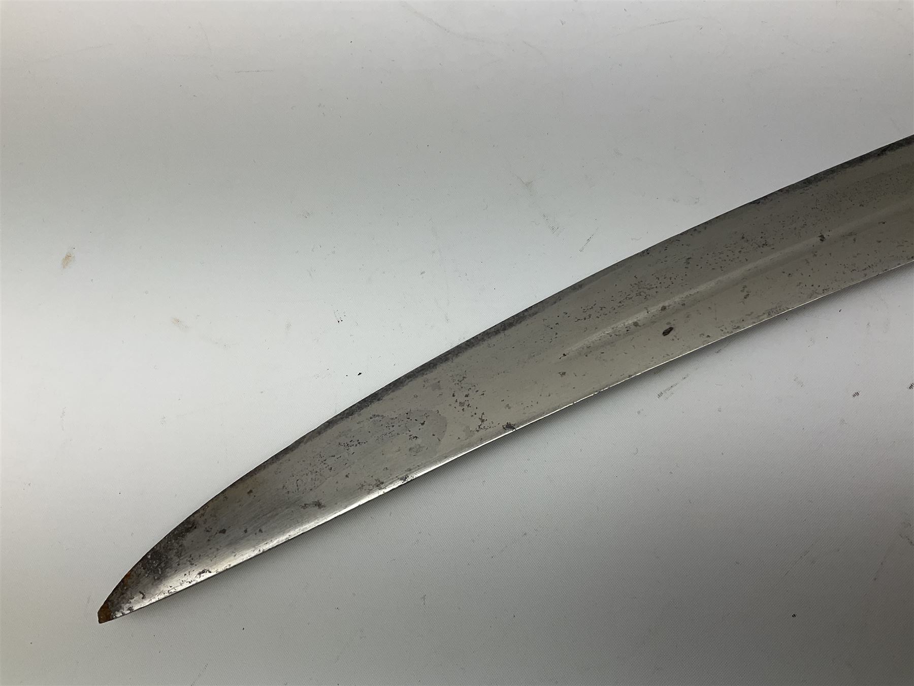 19th Century Indian Tulwar sword with 77cm single edged, slightly curved fullered blade;  steel crossguard, langets, grip and spiked disc pommel with stiff leaf decoration L90cm overall