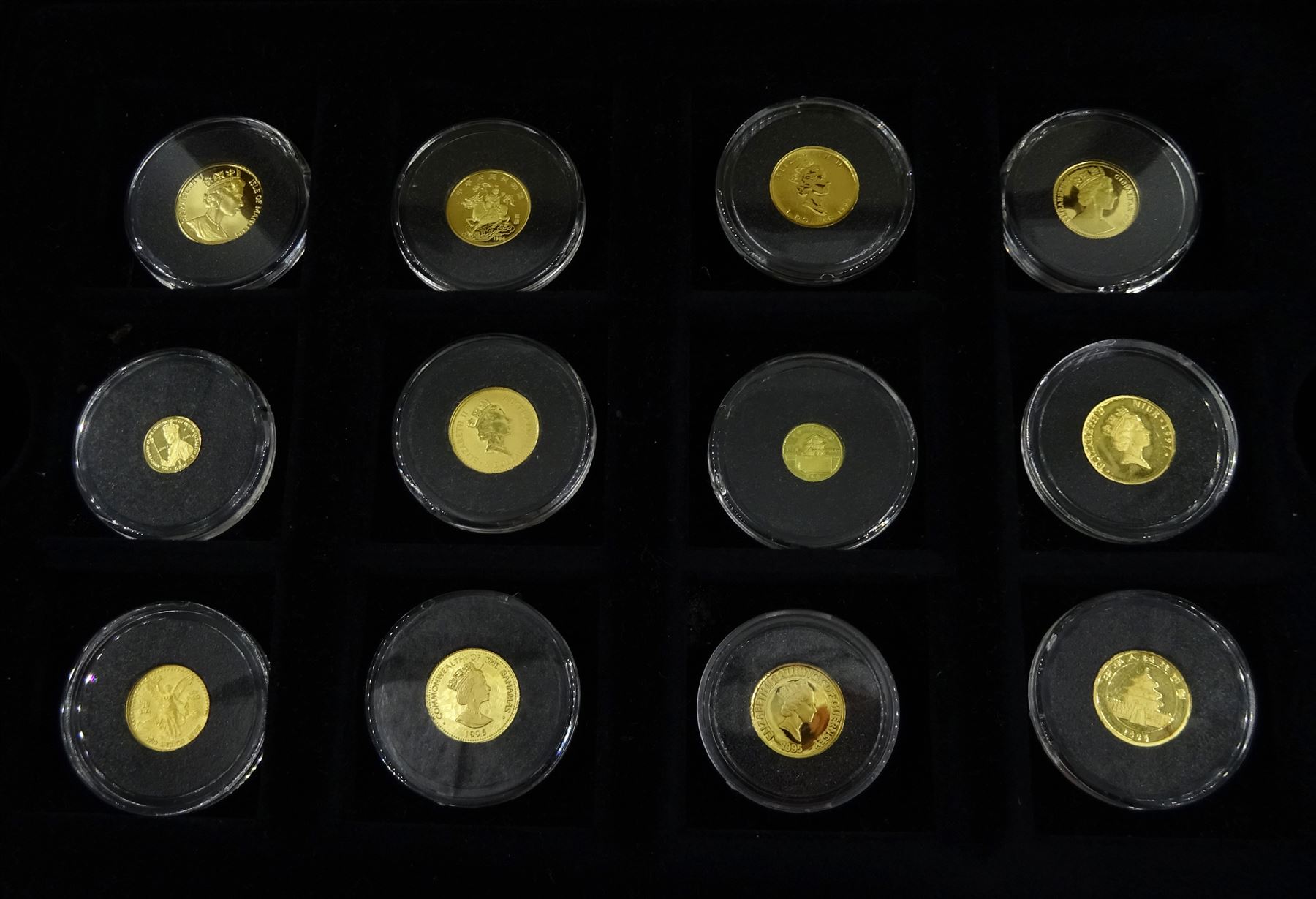 Fifteen gold coins from 'The Smallest Gold Coins of the World Collection', including Isle of Man 1989 1/25 ounce crown, Australia 1991 1/20 ounce five dollars, China 1995 1/20 ounce panda etc