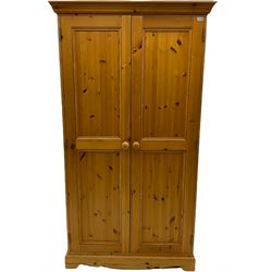 Solid pine double wardrobe, enclosed by two panelled doors