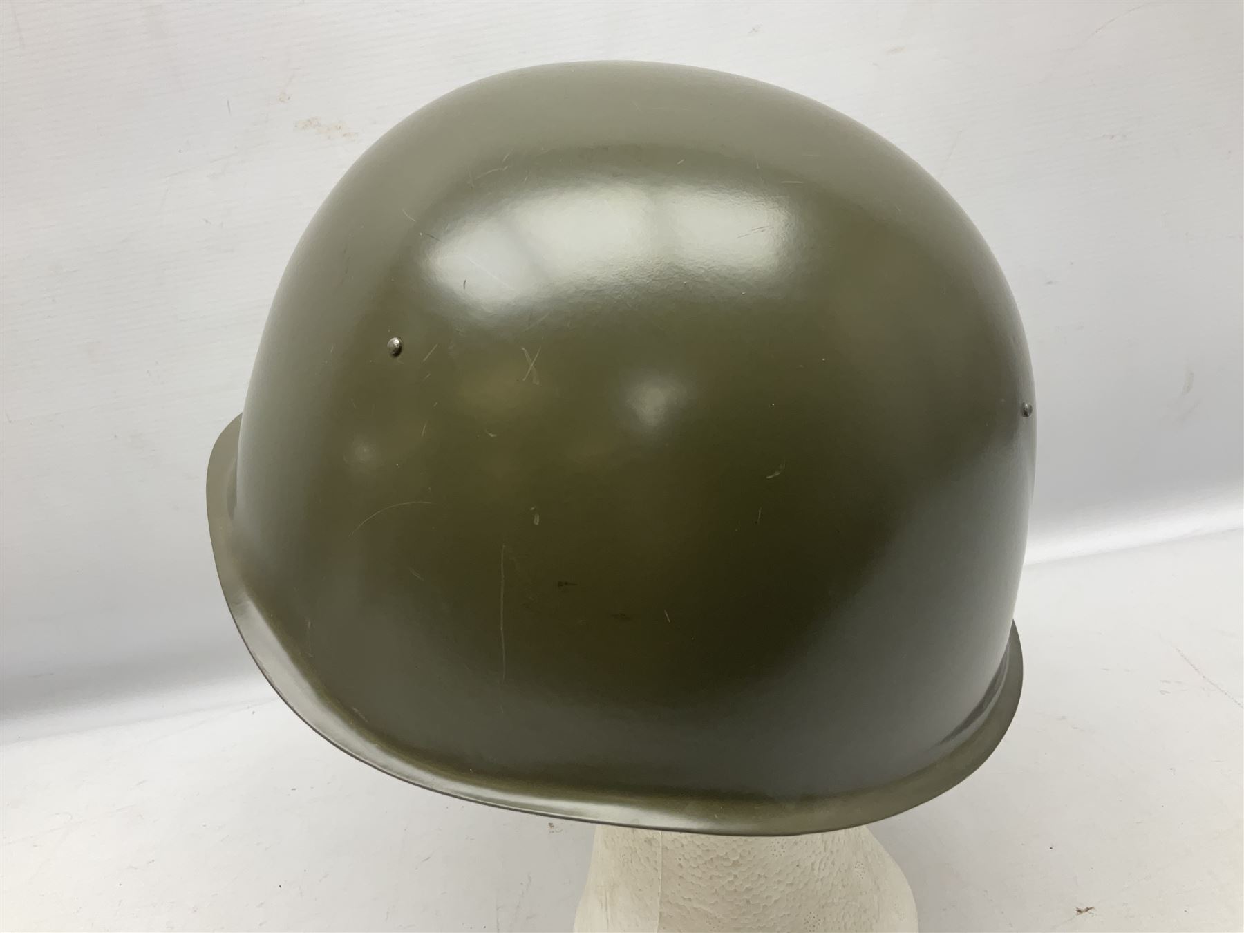 Two 1960s East Block Soviet style helmets - Czechoslovakian and Russian; both with liners (2)