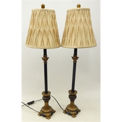  Pair ebonised table lamps on gilt reeded flared base and scroll feet, H80cm overall   