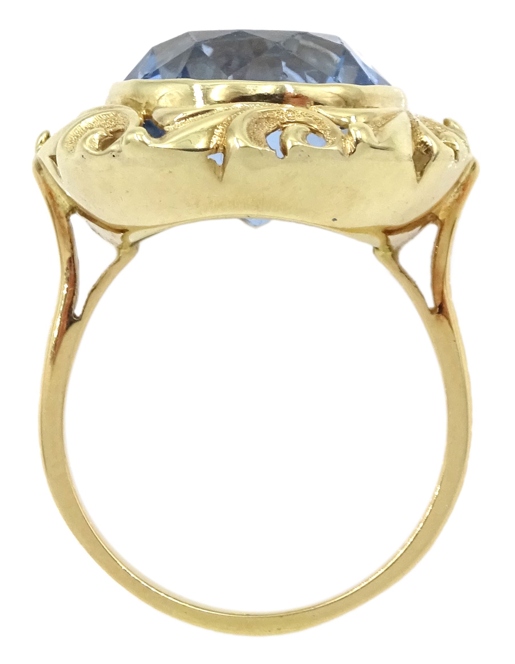 18ct gold single stone round synthetic blue spinel ring, with pierced leaf border