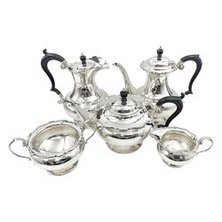 1920s five-piece silver tea service, comprising teapot, coffee pot, hot water pot, twin handled open sucrier and milk jug, each of squat circular form with shaped rim, the teapot, coffee pot and hot water pot each with ebonised handle and finial, the sucrier and milk jug with acanthus capped scroll handles, all upon circular foot, hallmarked R F Mosley & Co, Sheffield 1926 & 1927, tallest H24cm