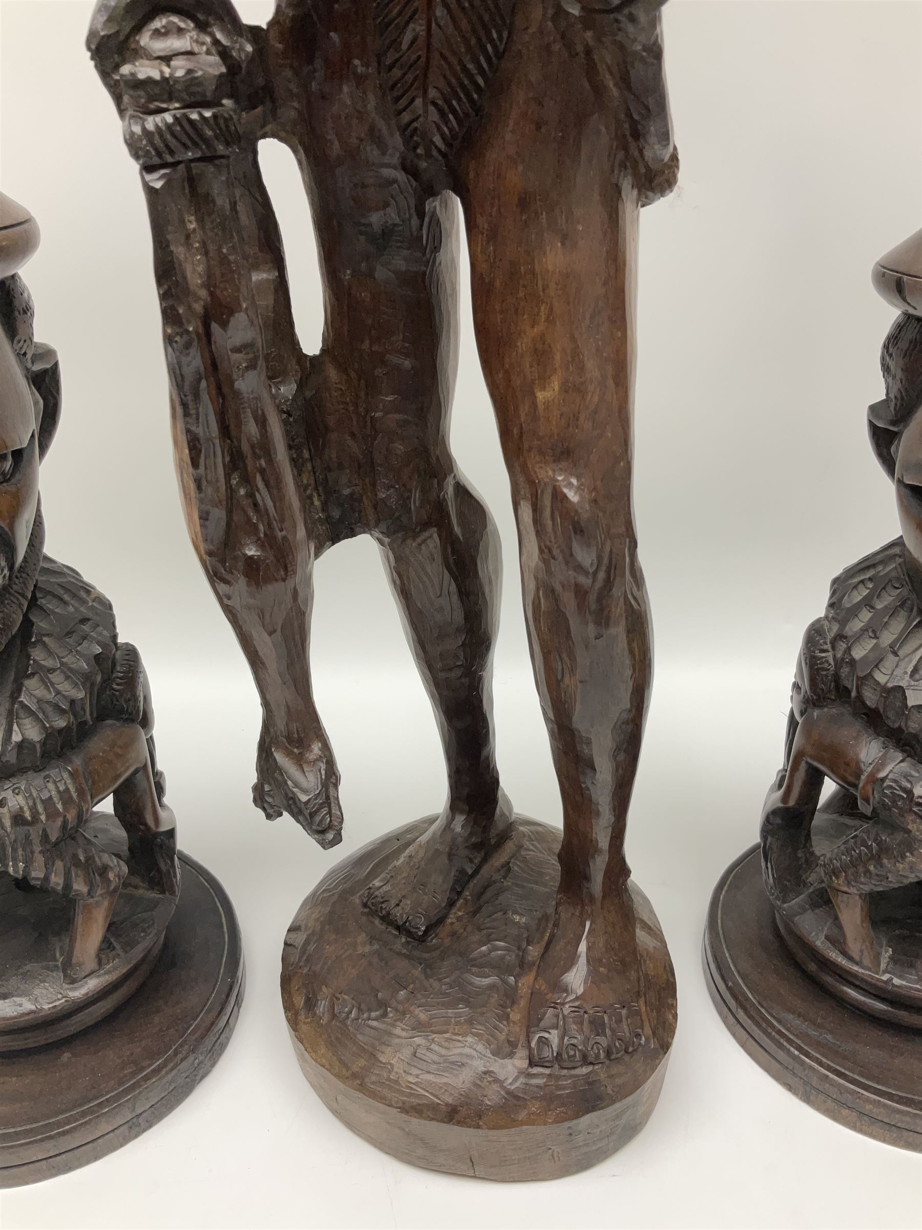 Pair of 20th century carved wood table lamp with African busts and figures, together with a carved wooden figure and soapstone figure, lamps H44cm