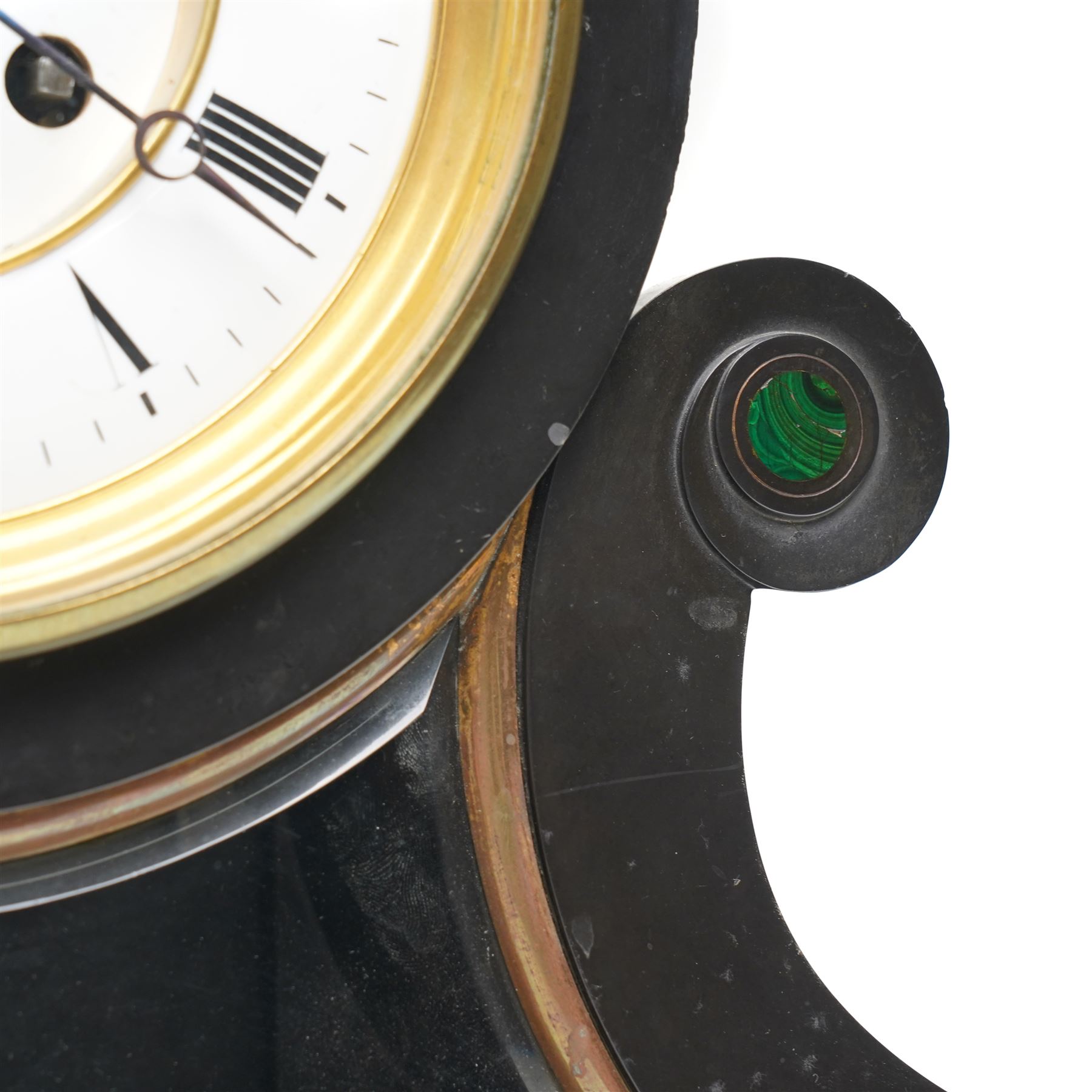 French-Late 19th century Belgium slate mantel clock, 8-day movement housed in a drum case with volutes, cradled within scroll supports and a shaped pendulum viewing glass with a brass surround, stepped plinth with incised decoration and malachite panels, two-piece enamel dial within a cast brass bezel, dial with Roman numerals, minute markers and steel moon hands, visible Brocot dead-beat escapement fitted with cornelian pallets, twin train going barrel movement with rack striking, sounding the hours and half-hours on a bell. With the original twin file mercury pendulum.
 