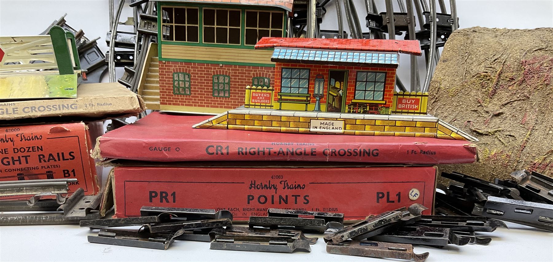 Hornby '0' gauge - layout accessories comprising PR1/PL1 Points, CR1 Right Angle Crossing and CA2 Acute Angle Crossing, all boxed; tin-plate signal box; tin-plate level crossing; textured wooden tunnel, possibly pre-WW2; and quantity of track, some boxed; together with '00' gauge tin-plate station