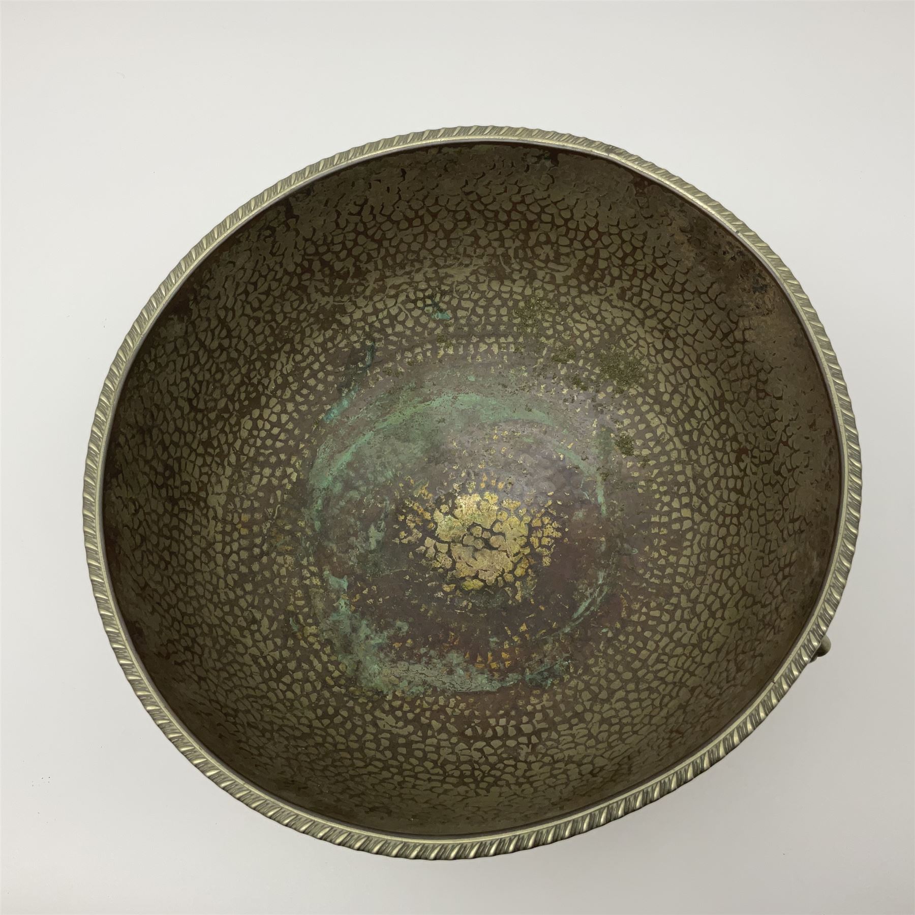 Copper pedestal punch bowl, with planished decoration with twin lion mask and ring handles and applied coins, H18cm