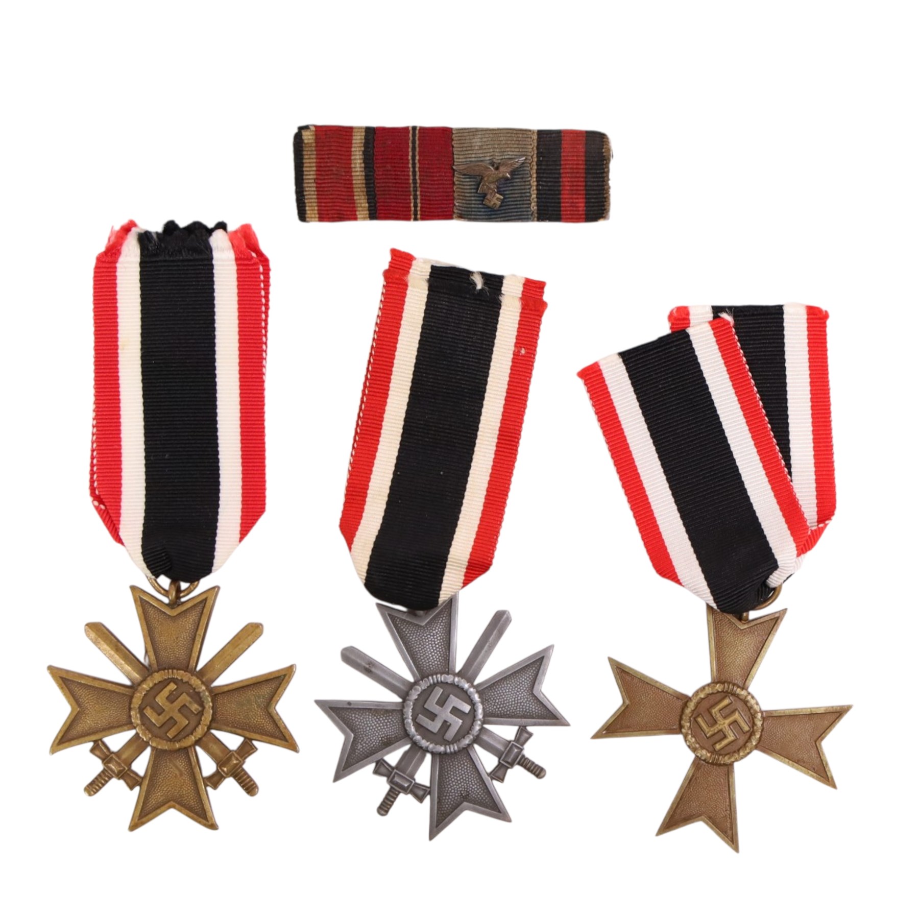 WWII Third Reich three War Merit Crosses, two with swords, together with a four piece medal bar with eagle 